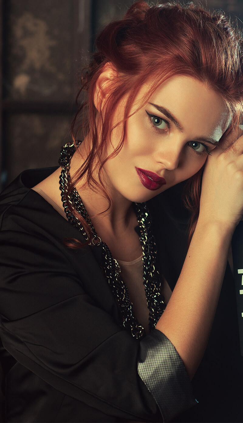 A girl with red hair and bright lipstick