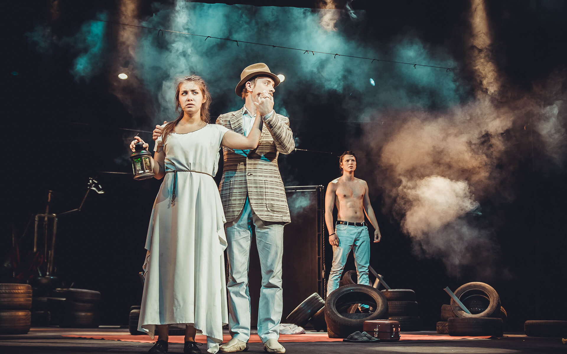 Two men and a woman on the stage of the theater