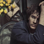 A man with a bicycle and a bouquet of yellow tulips